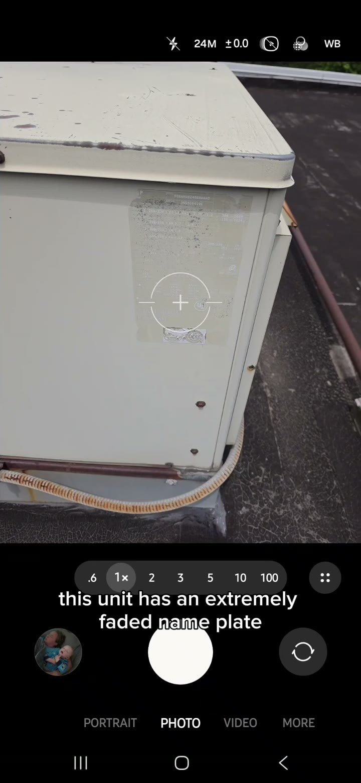 A phone camera about to scan the QR tag on a rooftop unit